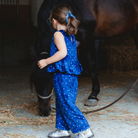 Navy Sequin Velvet Pants & Top Set with sparkle sequins, standing next to a horse, ready for any adventure.